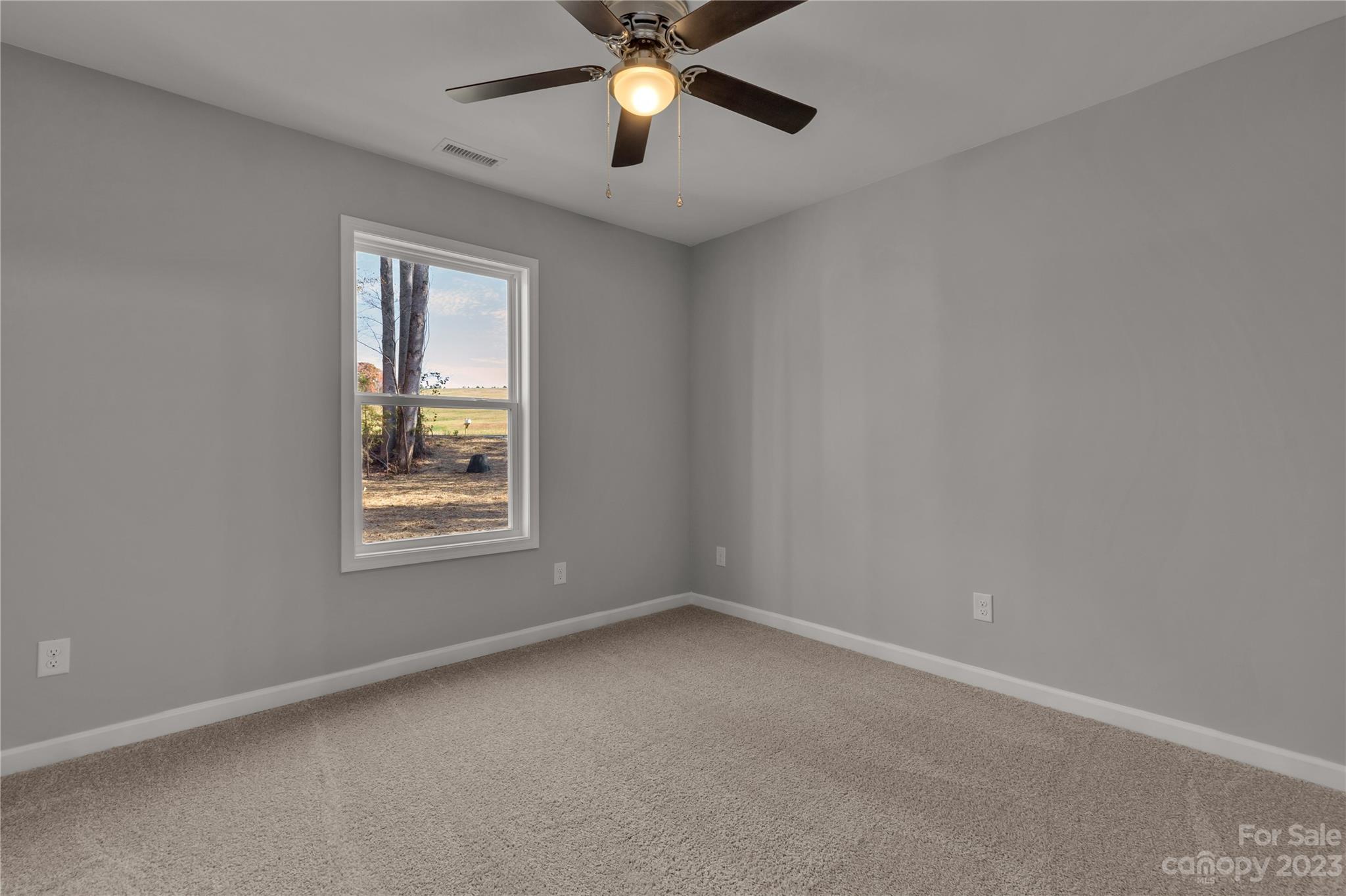 1191 Legion Road Hickory Grove, SC 29717 - Photo 20 of 32 an empty room with a window and a fan