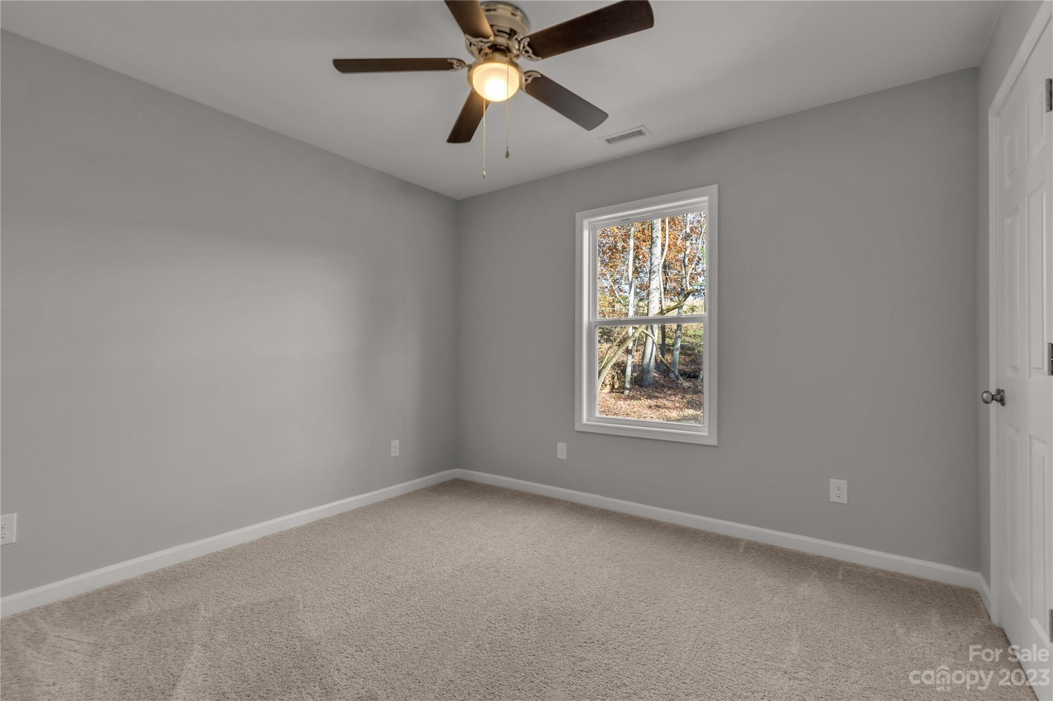 1191 Legion Road Hickory Grove, SC 29717 - Photo 22 of 32 an empty room with a window and a fan
