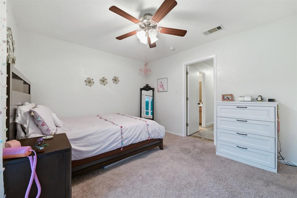 224 Overcrest Drive Benbrook, TX 76126 - Photo 23 of 39 a bedroom with a bed and a ceiling fan