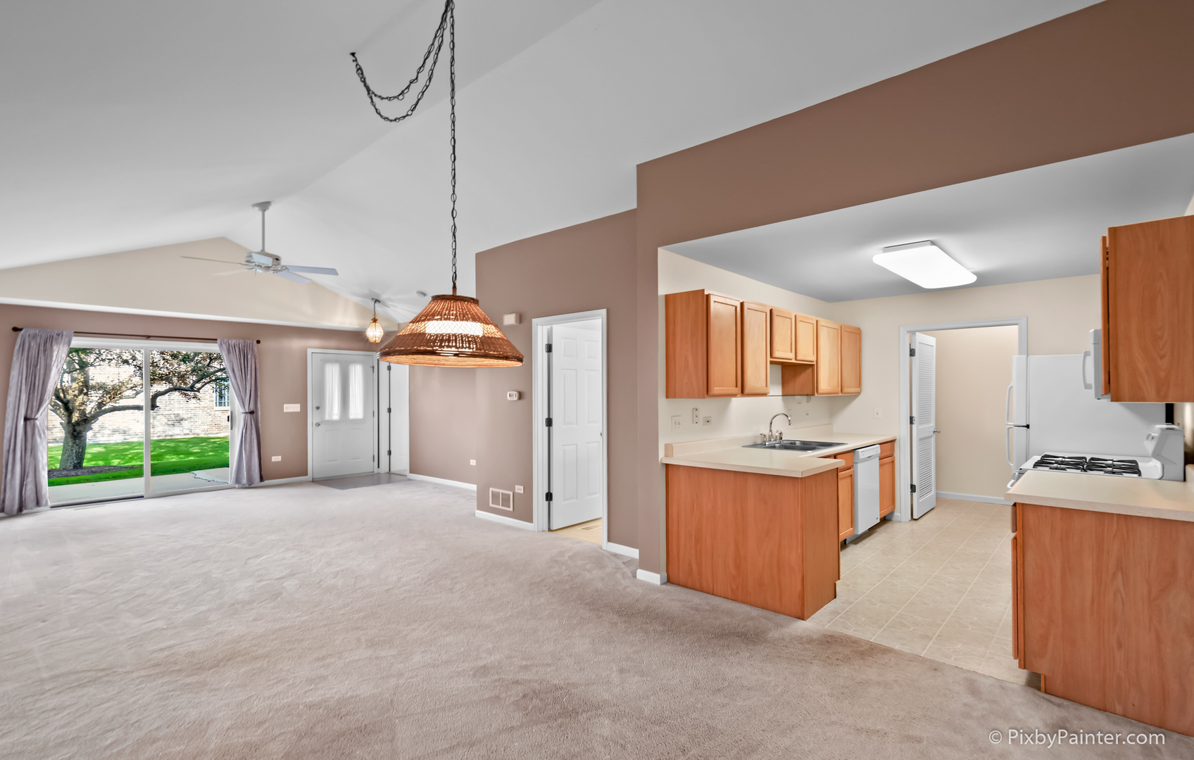 5714 Fieldstone Trail McHenry, IL 60050 - Photo 16 of 28 a view of a kitchen with kitchen island a large counter top space a sink a window and stainless steel appliances