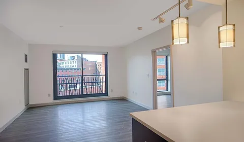a view of a room with wooden floor and windows