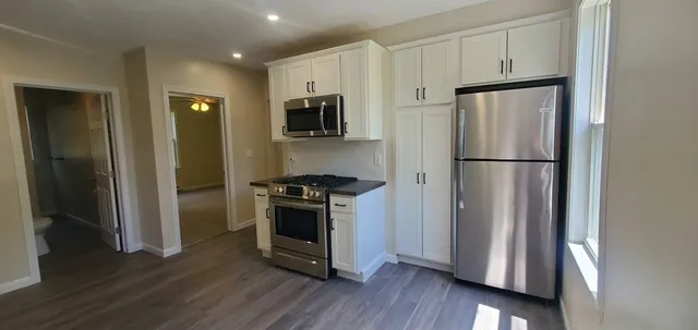 a kitchen with stainless steel appliances a refrigerator sink and microwave