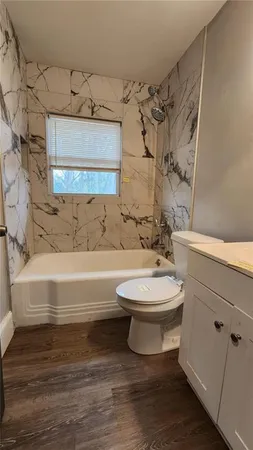a bathroom with a toilet sink and shower