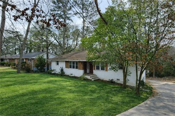 a front view of house with yard and green space