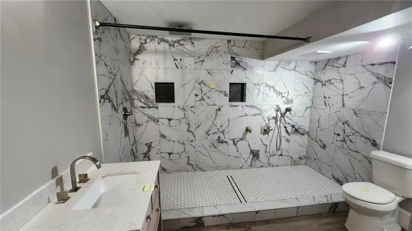 an empty room with wooden floor and closet