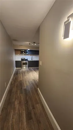 a kitchen with granite countertop a refrigerator stove top oven and sink