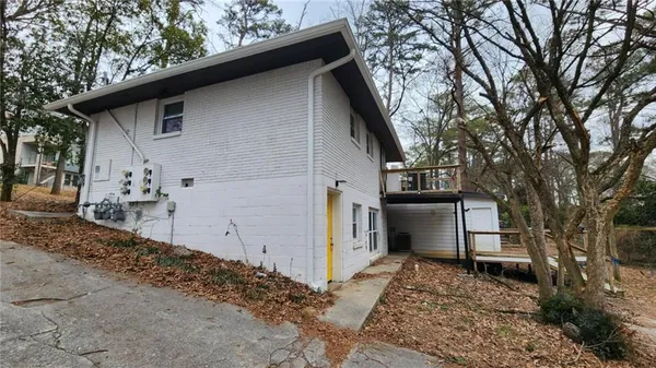 a house that has a tree in front of the house