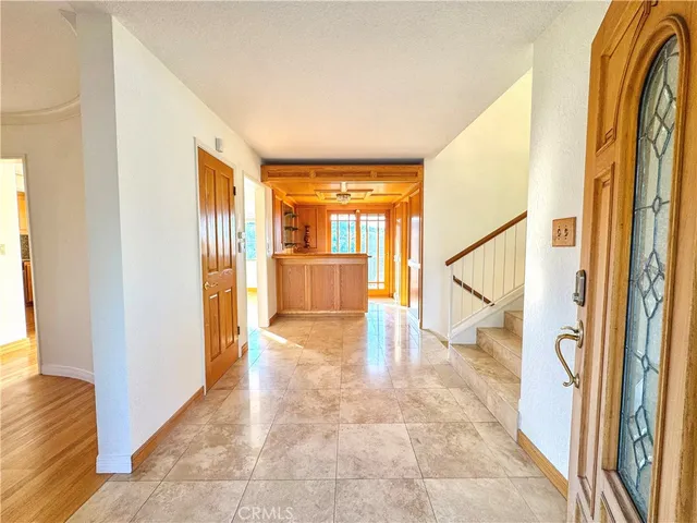 a view of a hallway with wooden floor and glass door