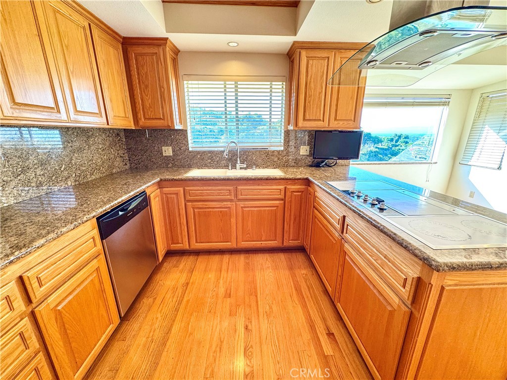 2821 Colt Road Rancho Palos Verdes, CA 90275 - Photo 9 of 42 a kitchen with stainless steel appliances granite countertop wooden floor a sink and a stove