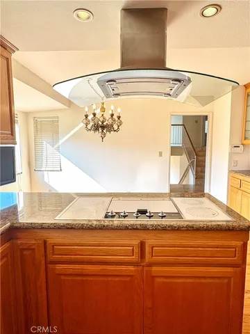 a kitchen with stainless steel appliances a refrigerator and wooden floor