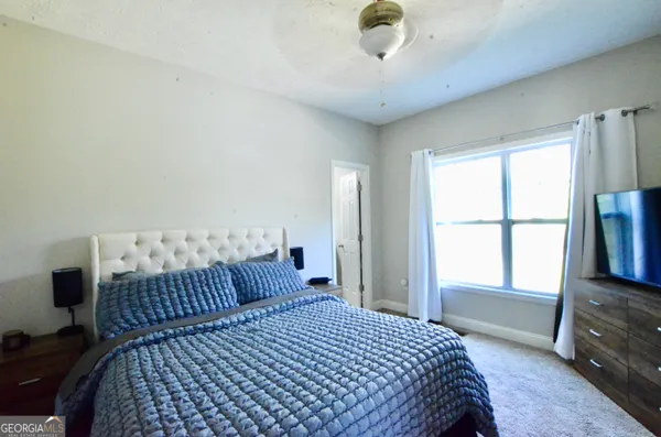 a bedroom with a bed and a window