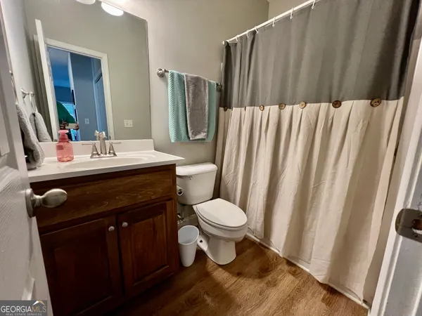a bathroom with a sink toilet and mirror