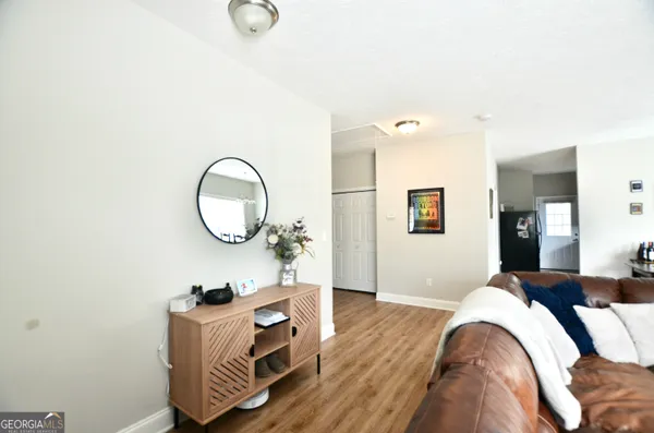 a living room with furniture and a mirror