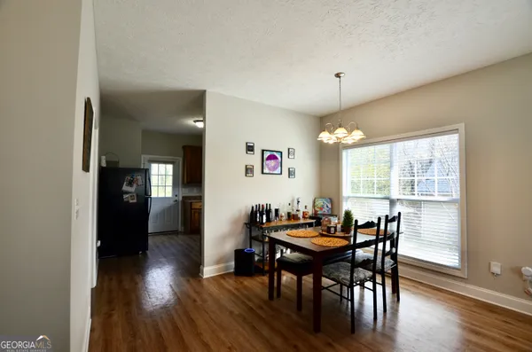 a view of a dining room with furniture window and wooden floor