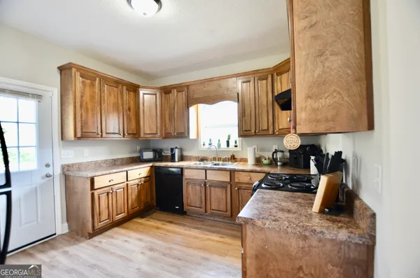 a kitchen with stainless steel appliances granite countertop a stove sink and cabinets