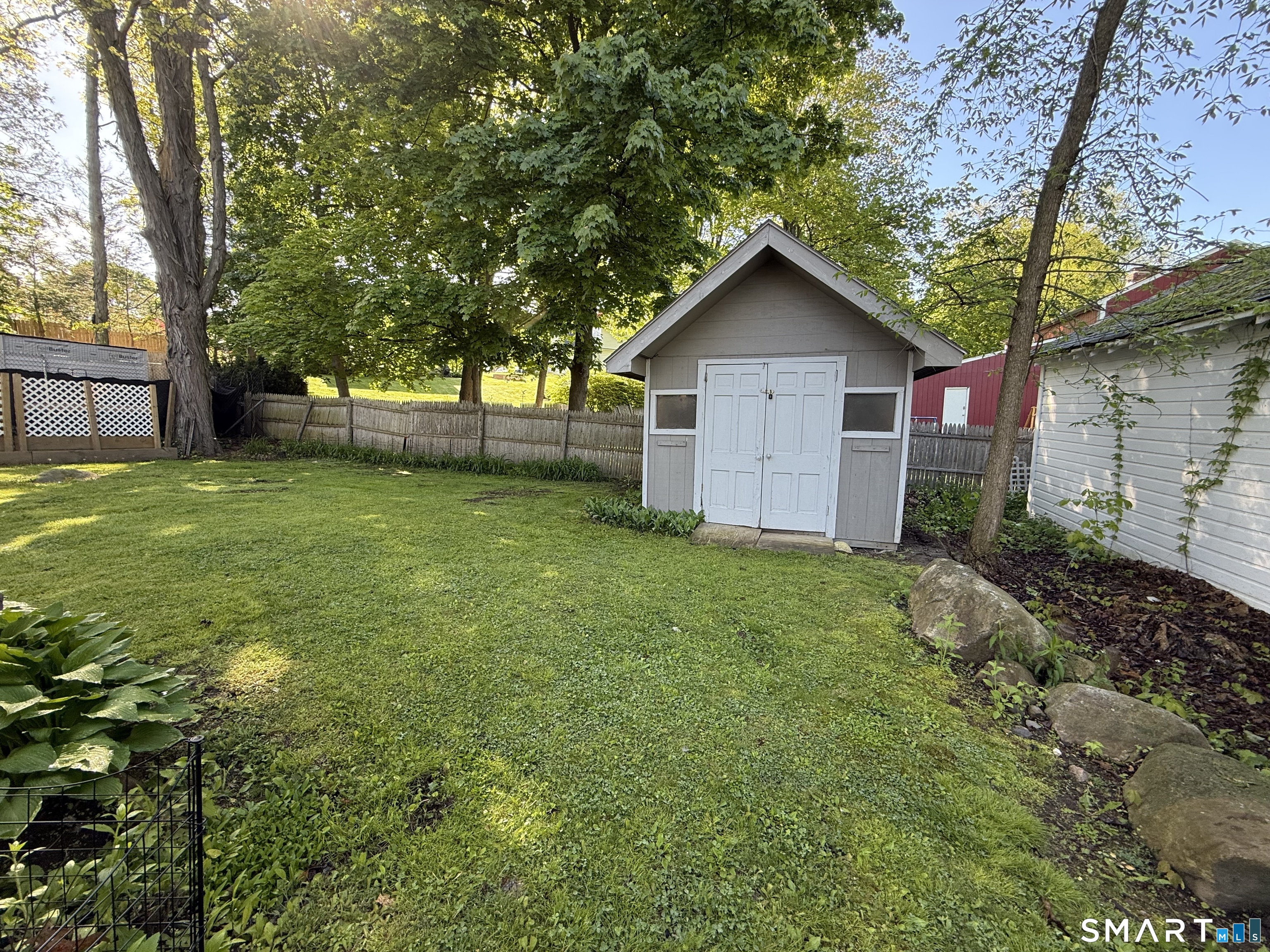 808 East Main Street Torrington, CT 06790 - Photo 8 of 40 a house view with a garden and trees