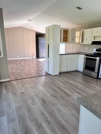 a view of a kitchen with microwave and cabinets