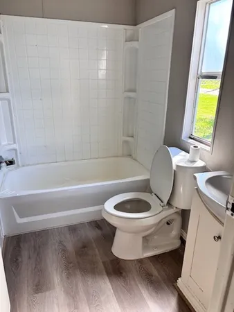 a bathroom with a toilet a sink and a bathtub