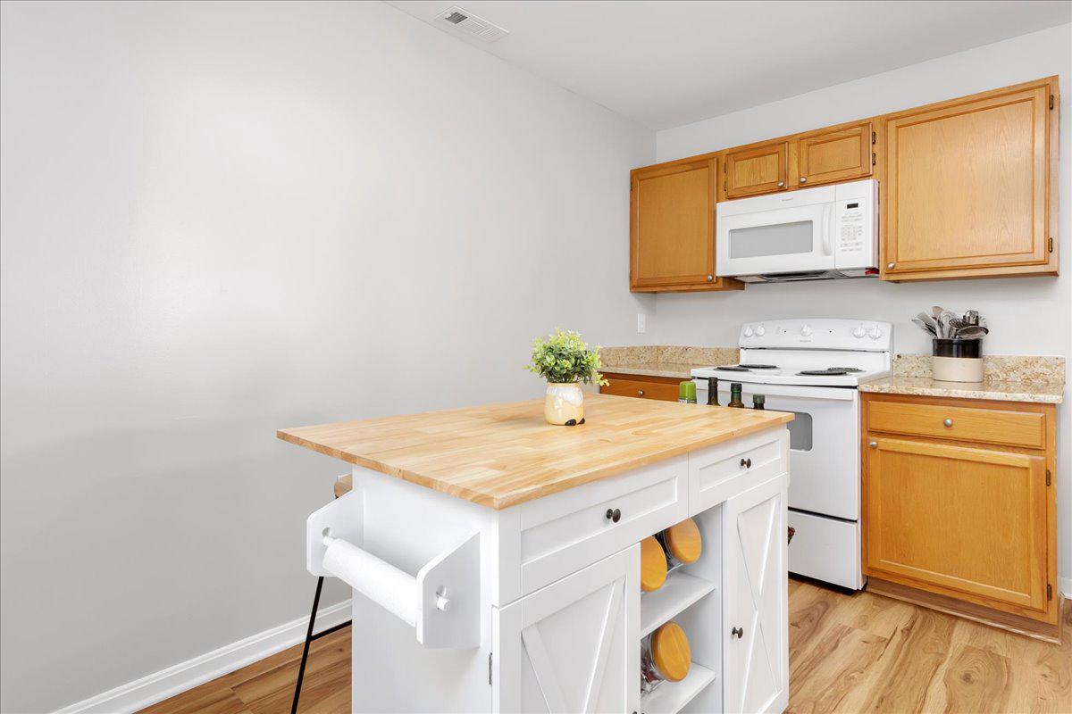 2610 Warren Way, Unit 37 Frederick, MD 21701 - Photo 16 of 42 a utility room with a sink a stove and wooden floor