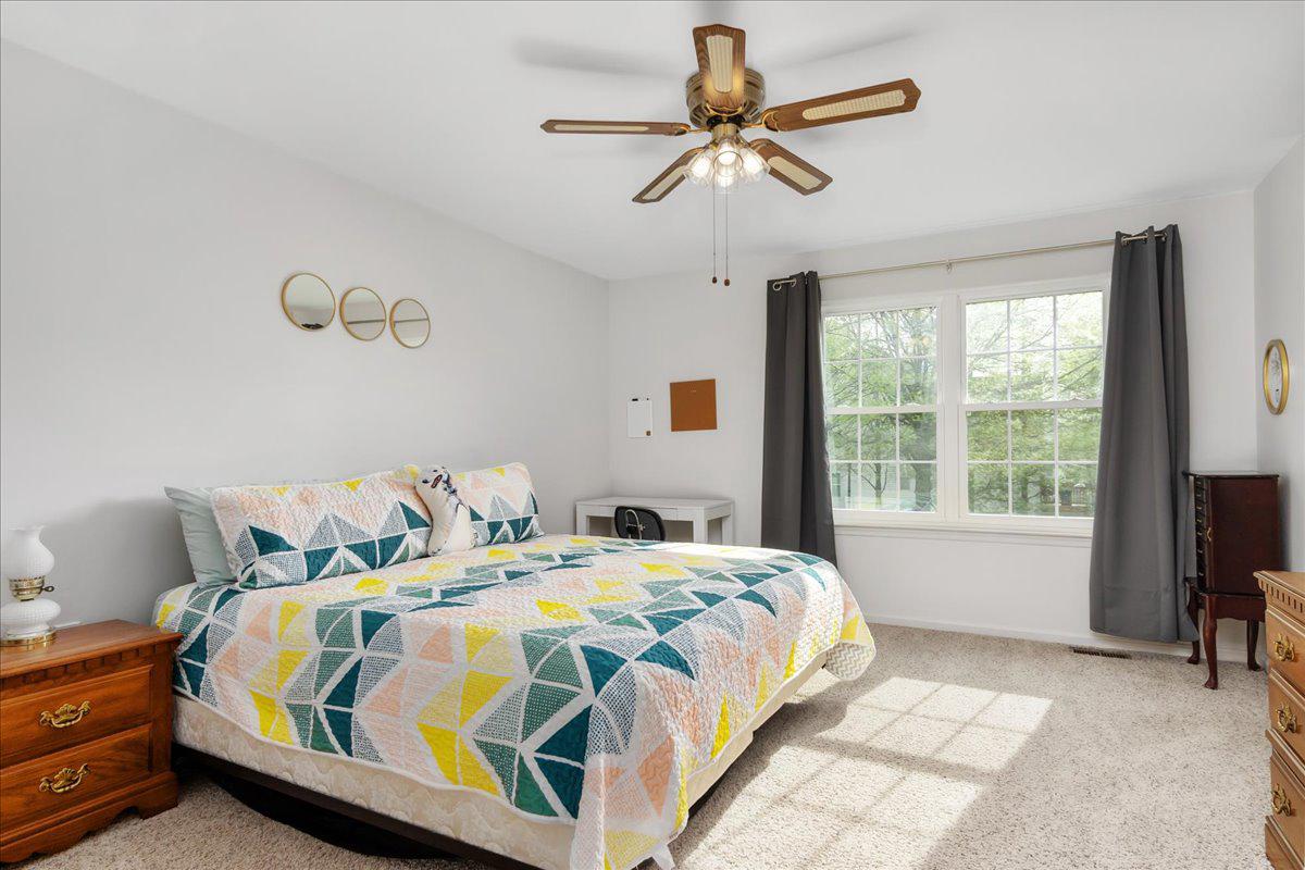 2610 Warren Way, Unit 37 Frederick, MD 21701 - Photo 22 of 42 a bedroom with a bed a chandelier and a window