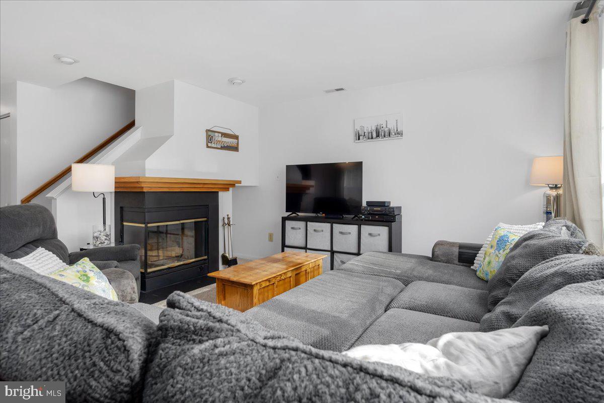 2610 Warren Way, Unit 37 Frederick, MD 21701 - Photo 6 of 42 a living room with furniture a flat screen tv and a fireplace