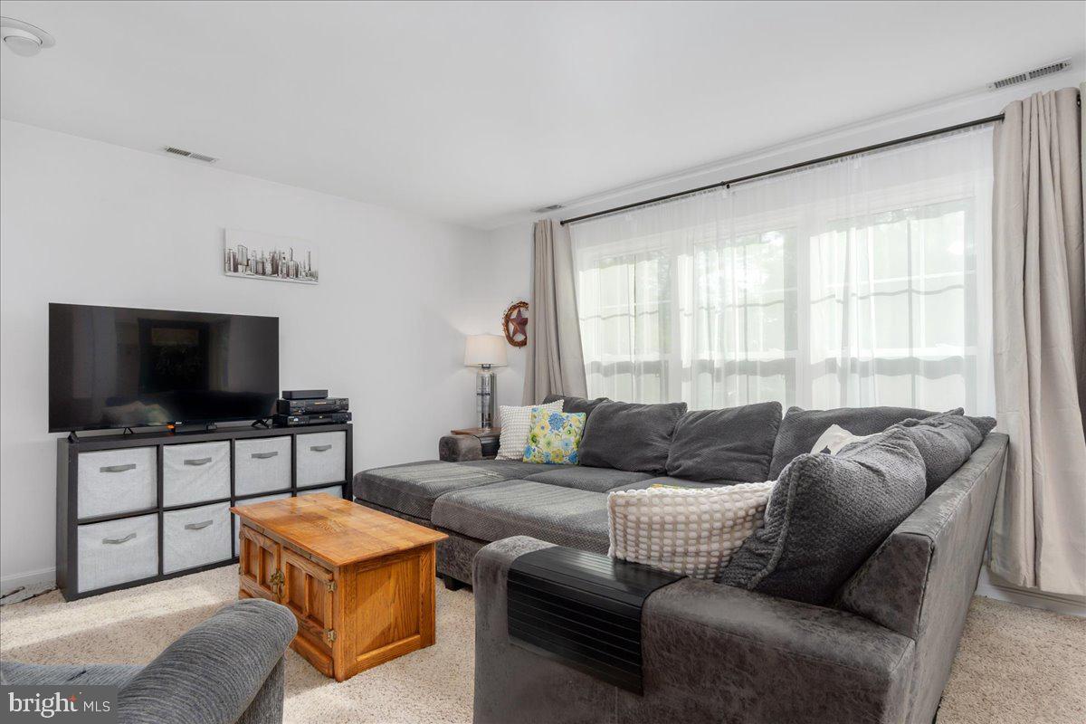 2610 Warren Way, Unit 37 Frederick, MD 21701 - Photo 7 of 42 a living room with furniture and a flat screen tv