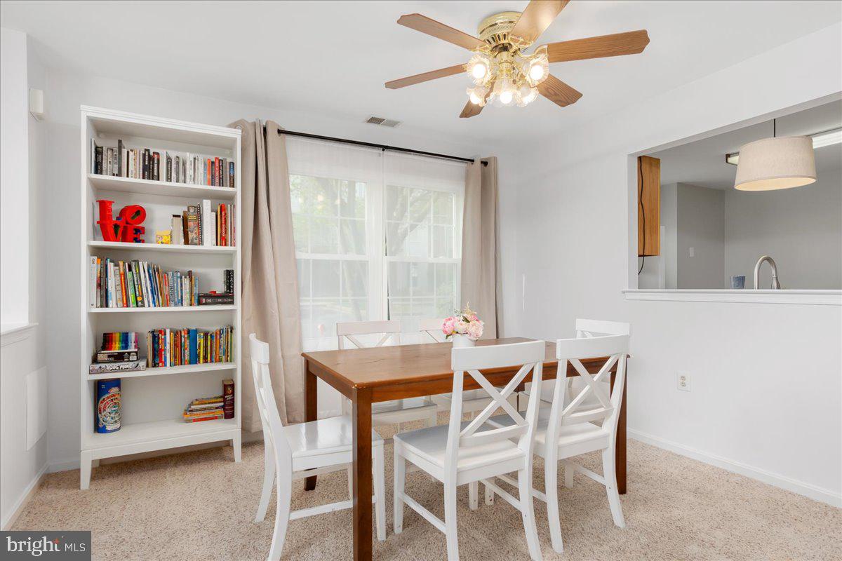2610 Warren Way, Unit 37 Frederick, MD 21701 - Photo 10 of 42 a dining room with furniture and a book shelf