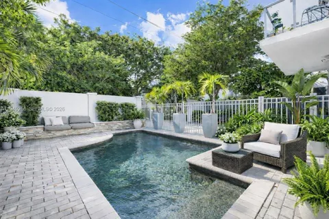 a view of a patio with couches table and chairs and potted plants