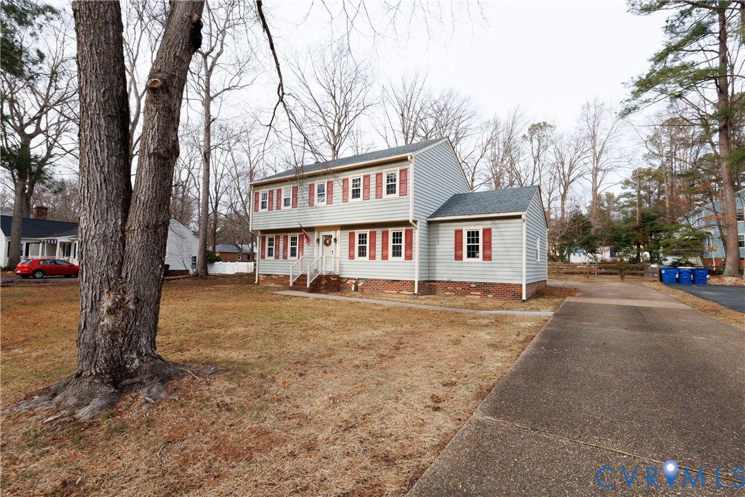 111 Arkwright Road North Chesterfield, VA 23236 - Photo 2 of 24 a view of a house with a yard covered with snow in the background