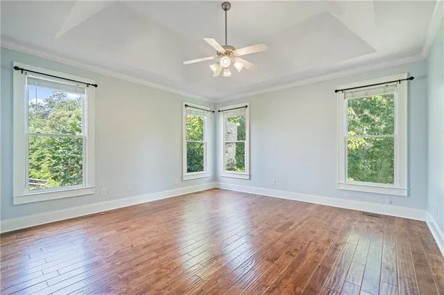 a view of staircase with wooden floor and white walls