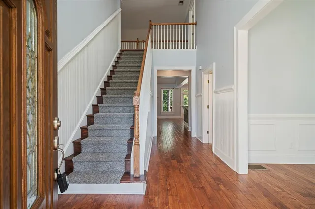 a view of a kitchen with kitchen island a counter top space cabinets and stainless steel appliances