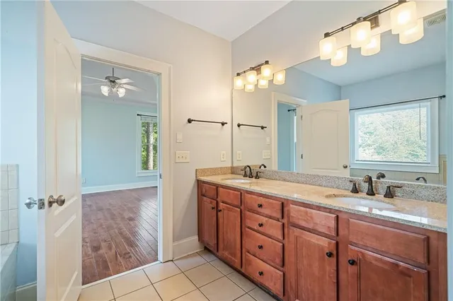 a bathroom with a double vanity sink mirror and shower