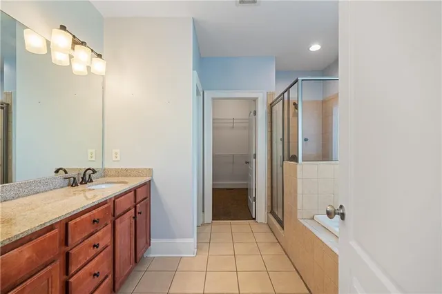 a bathroom with a granite countertop toilet a sink and a bathtub