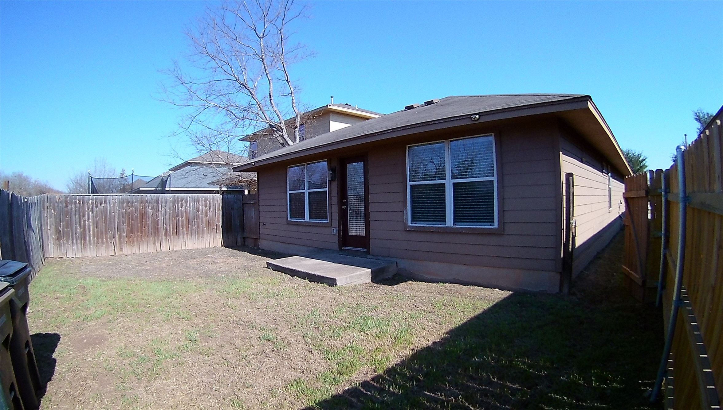3304 Wickham Lane Austin, TX 78725 - Photo 13 of 13 Back of house with a fenced backyard