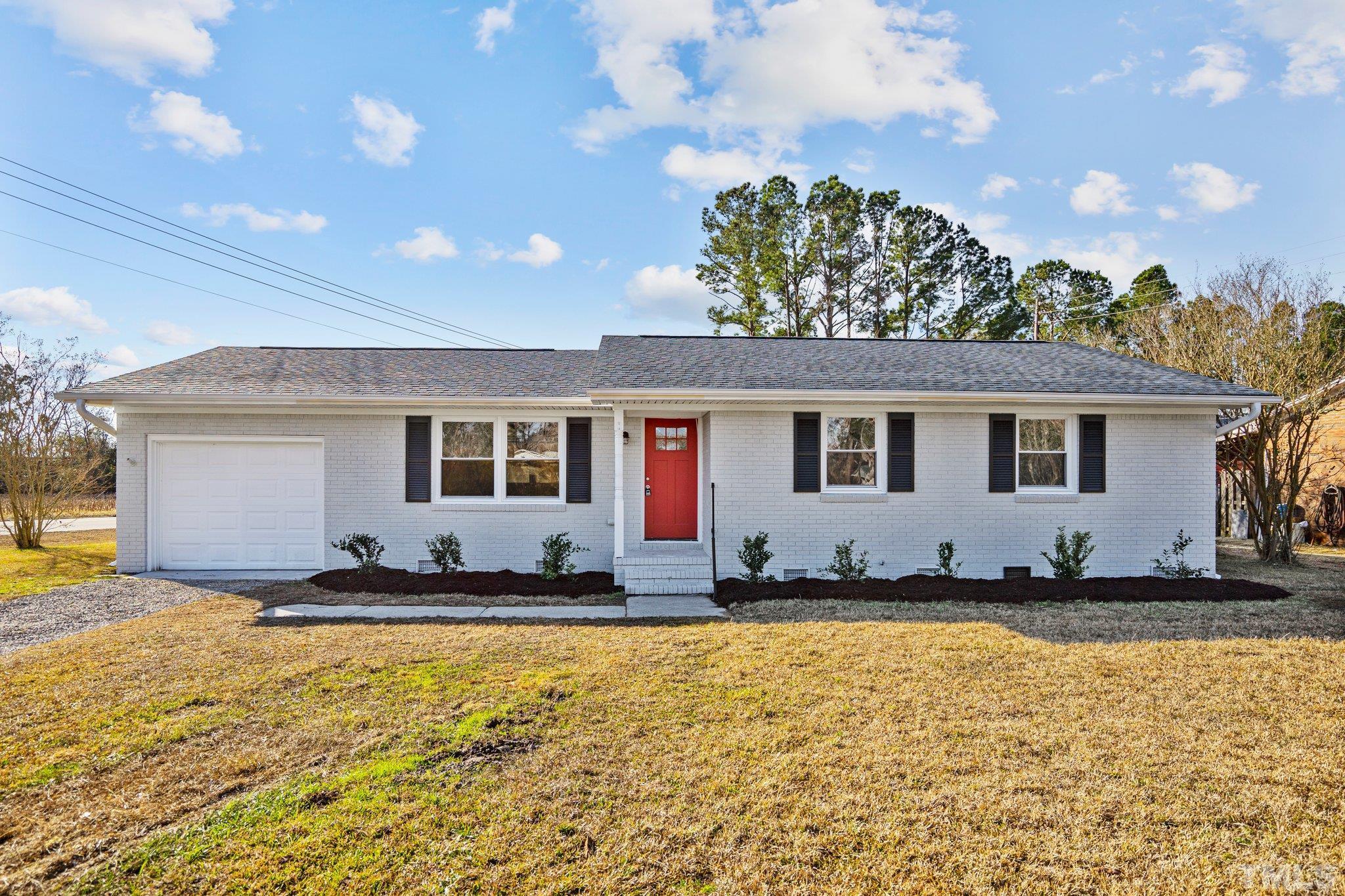101 Holly Road Castle Hayne, NC 28429 - Photo 1 of 31 a front view of a house with a yard