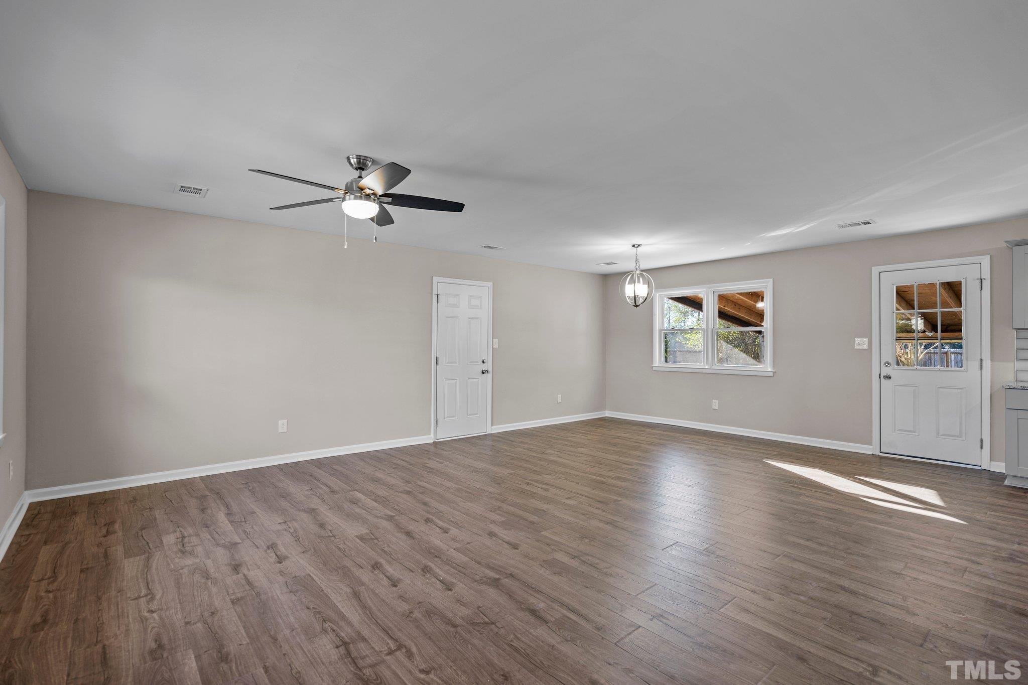 101 Holly Road Castle Hayne, NC 28429 - Photo 11 of 31 a view of an empty room with a window and wooden floor
