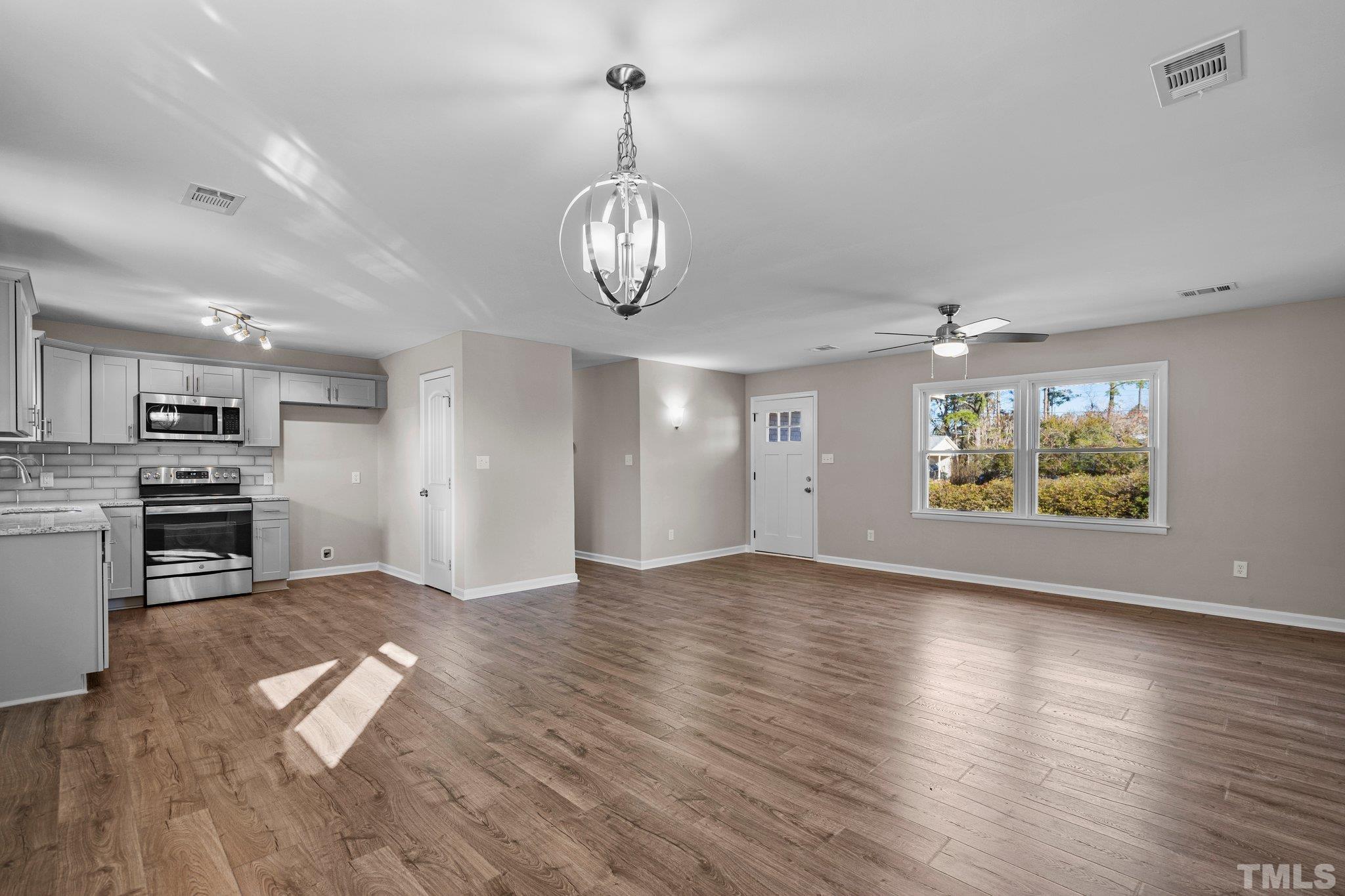 101 Holly Road Castle Hayne, NC 28429 - Photo 2 of 31 wooden floor in an empty room with a window
