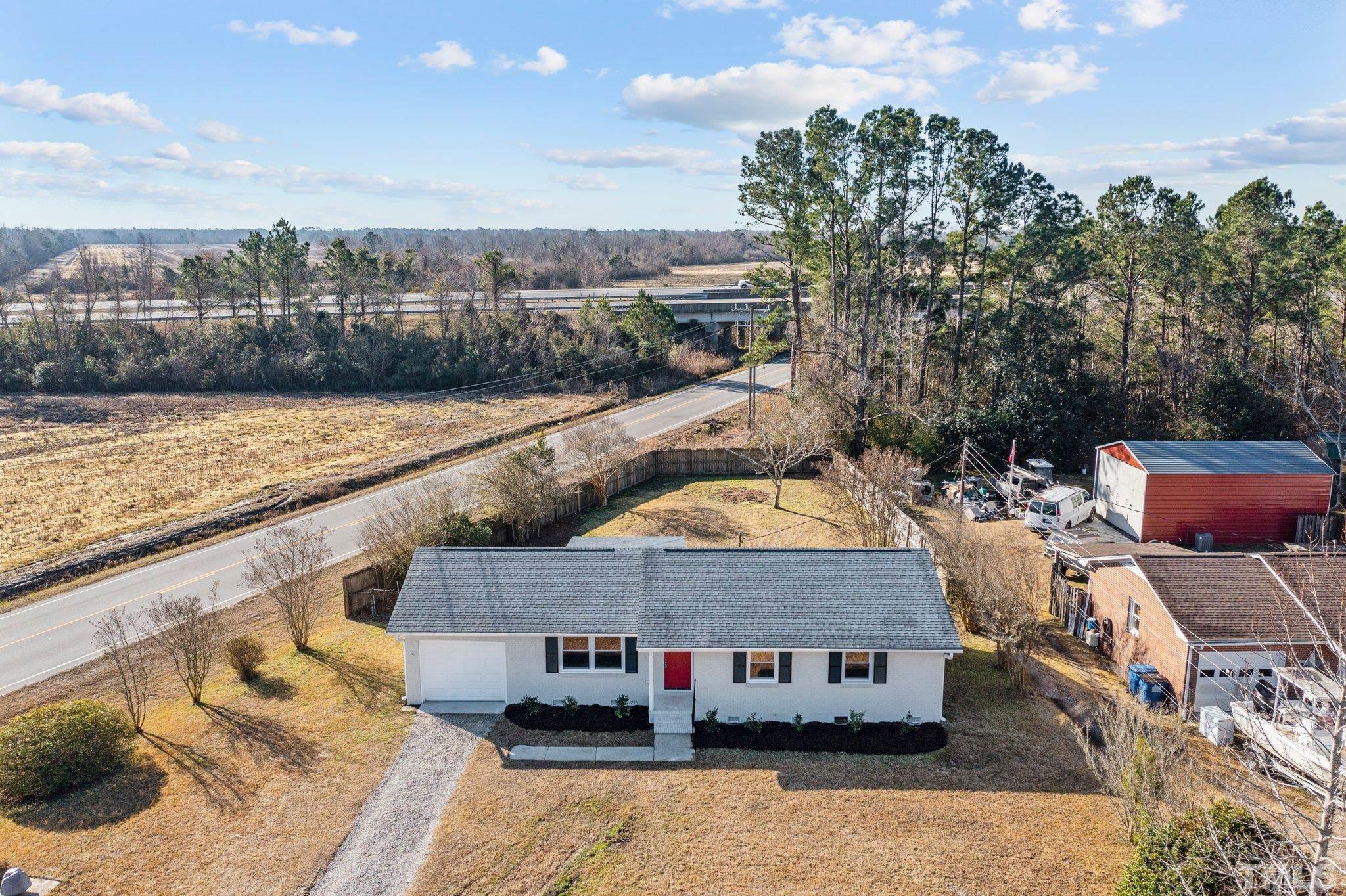 101 Holly Road Castle Hayne, NC 28429 - Photo 25 of 31 a aerial view of a house with swimming pool and large trees