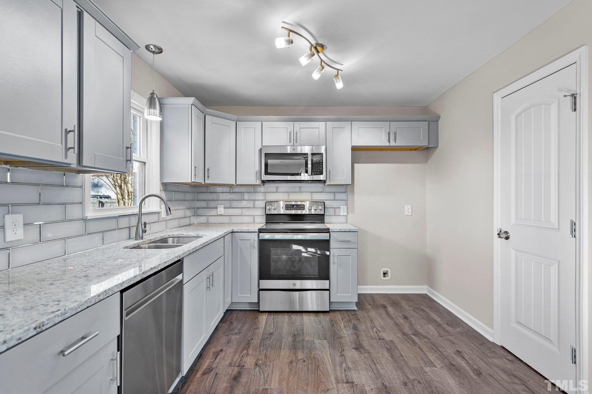 101 Holly Road Castle Hayne, NC 28429 - Photo 6 of 31 a kitchen with granite countertop a sink and steel appliances