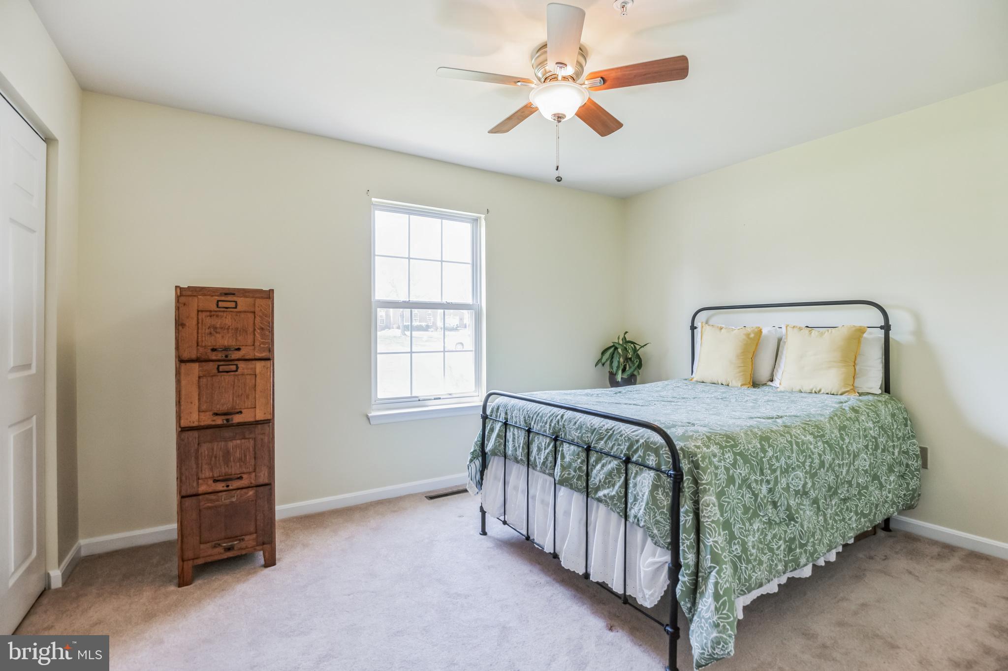 540 Small Reward Road Huntingtown, MD 20639 - Photo 19 of 26 a bedroom with a bed and a window