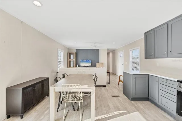 a living room with granite countertop furniture and a wooden floor