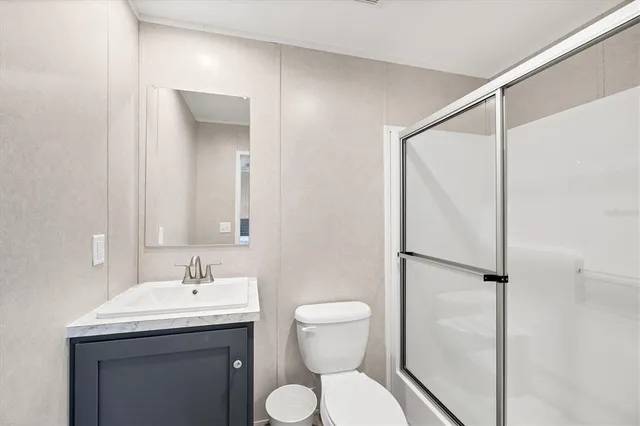 a bathroom with a toilet sink and shower