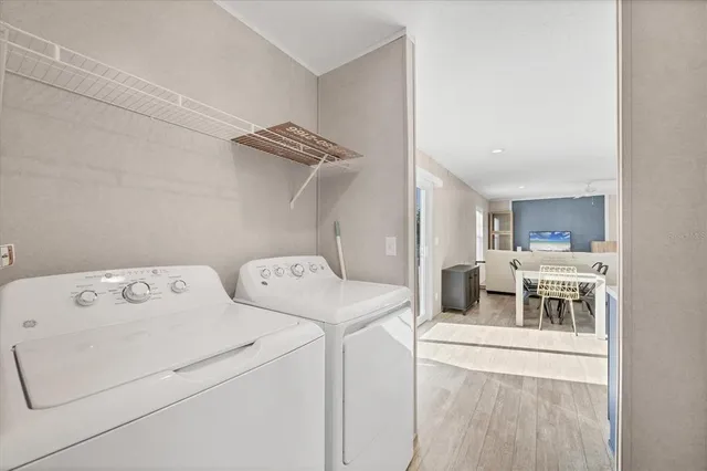 a view of washer and dryer with kitchen in the background