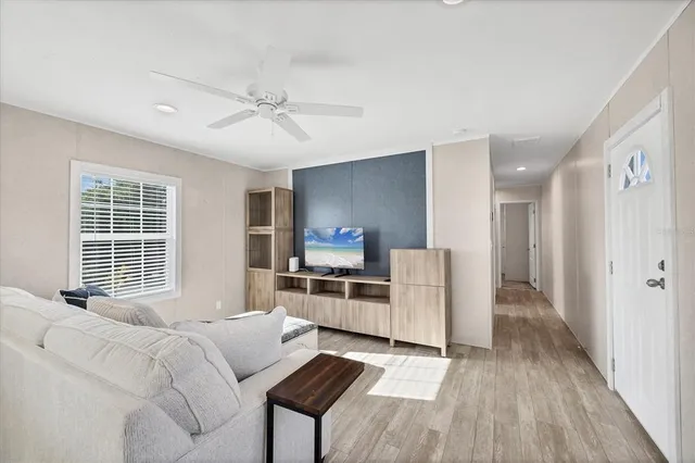 a kitchen with stainless steel appliances granite countertop a stove top oven a sink dishwasher and a refrigerator with wooden floor