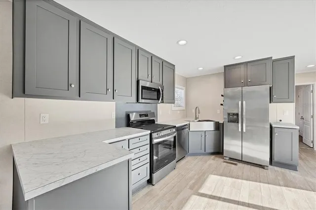 a kitchen with a sink a stove and refrigerator