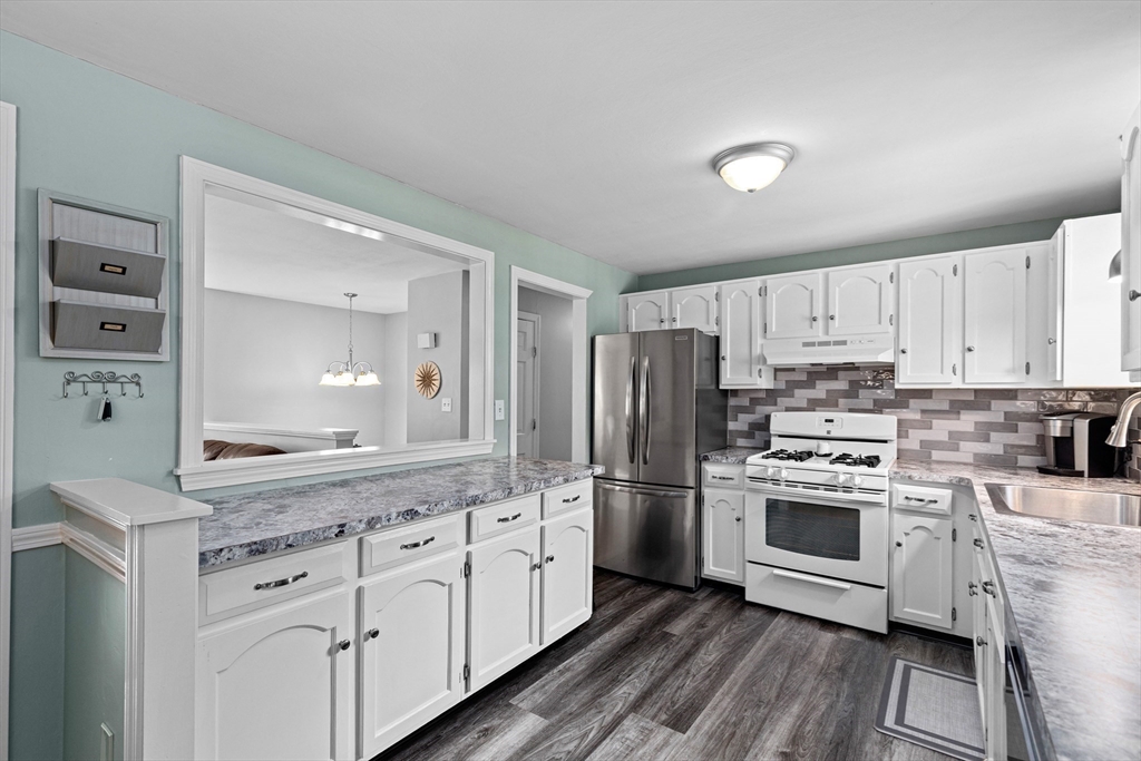 29 Worrall Road Plymouth, MA 02360 - Photo 11 of 38 a kitchen with white cabinets and stainless steel appliances