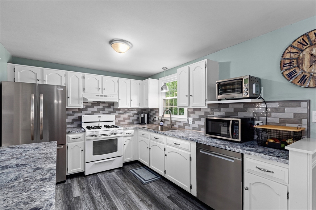 29 Worrall Road Plymouth, MA 02360 - Photo 12 of 38 a kitchen with a sink a stove a refrigerator and cabinets