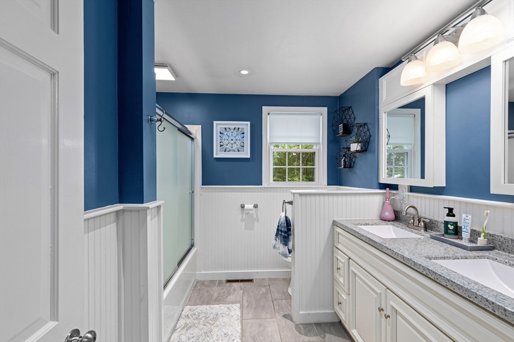 29 Worrall Road Plymouth, MA 02360 - Photo 24 of 38 a bathroom with a granite countertop sink a mirror and a bathtub