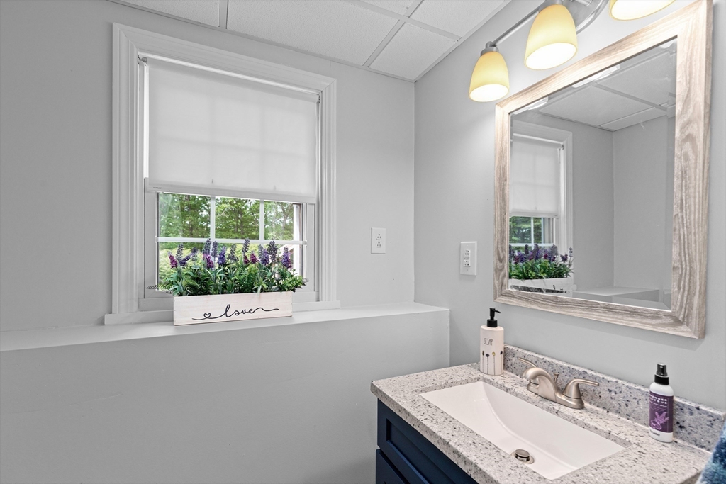 29 Worrall Road Plymouth, MA 02360 - Photo 33 of 38 a bathroom with a granite countertop sink a mirror and a window