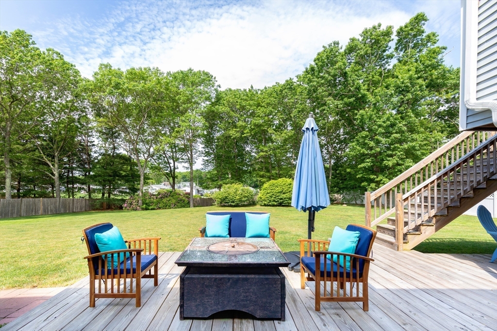29 Worrall Road Plymouth, MA 02360 - Photo 6 of 38 a view of a roof deck with table and chairs couches with wooden floor and fence
